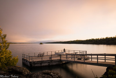 An intern ranger watching an awesome sunset from the America Dock. He was a really nice guy and let me go up on the rocks there to get a better view